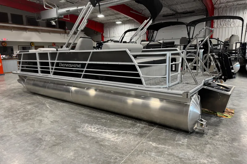 Slide: The Image of 2026 Berkshire 24 UL LE pontoon boat in showroom, featuring sleek design and modern amenities. - 3