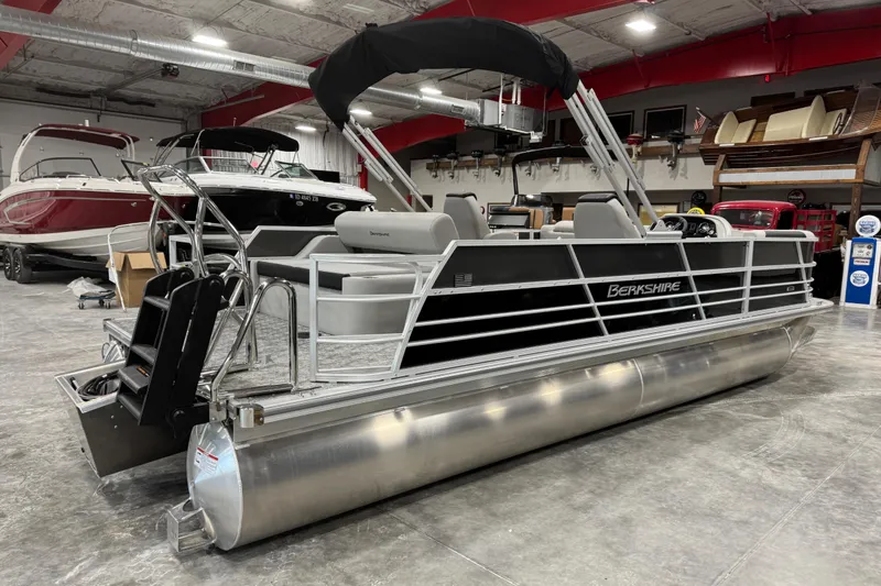 Slide: The Image of 2026 Berkshire 24 UL LE pontoon boat in showroom, featuring sleek design and modern amenities. - 5