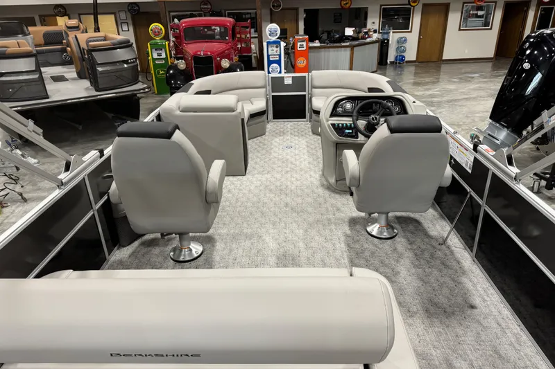 Slide: The Image of 2026 Berkshire 24 UL LE pontoon boat interior with modern seating and steering console. - 6