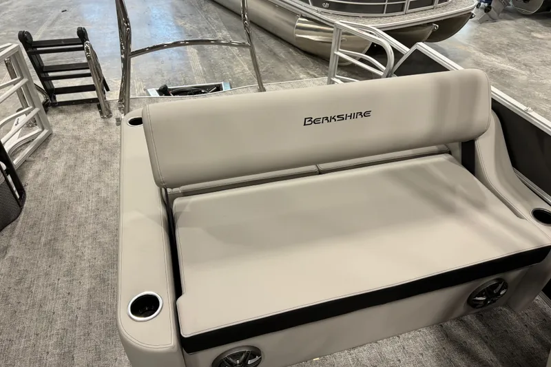 Slide: The Image of 2026 Berkshire 24 UL LE boat interior with cushioned seating and cup holders. - 8