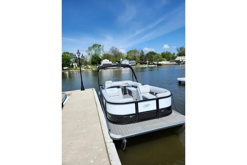 The Image of 2023 Bentley Pontoons Legacy 200 Cruise docked on a sunny day by the lake. - 0