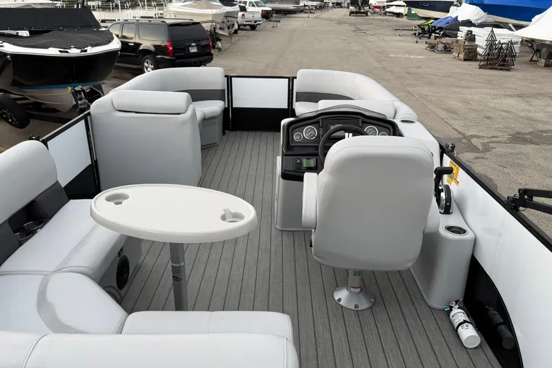 Slide: The Image of 2023 Bentley Pontoons Legacy 200 Cruise interior with seating and steering console. - 12
