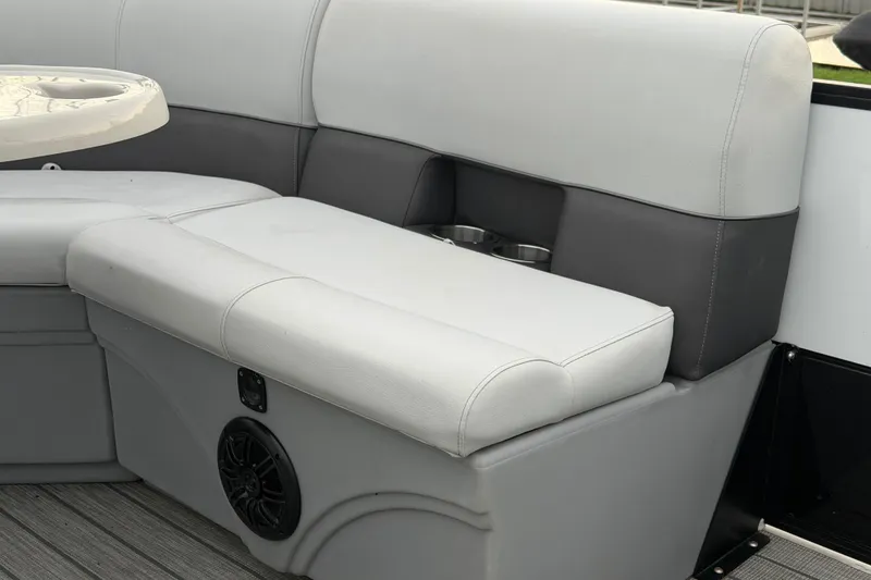 Slide: The Image of 2023 Bentley Pontoons Legacy 200 Cruise interior seating with cup holders and speaker. - 13