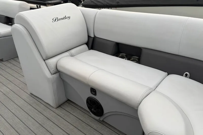 Slide: The Image of 2023 Bentley Pontoons Legacy 200 Cruise interior with luxurious seating and cup holders. - 14