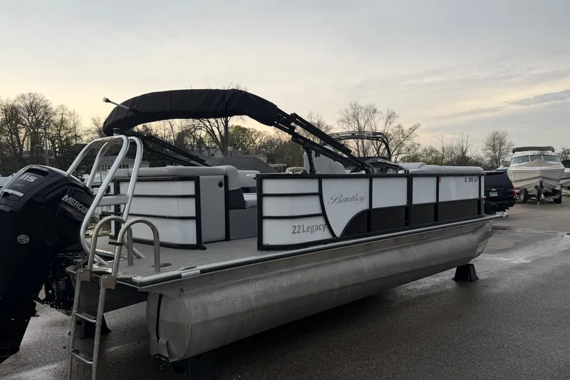 Slide: The Image of 2023 Bentley Pontoons Legacy 200 Cruise pontoon boat with Mercury engine, parked outdoors. - 3