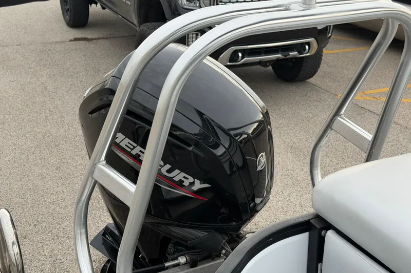 Slide: The Image of 2023 Bentley Pontoons Legacy 200 Cruise with Mercury outboard motor in parking lot. - 6