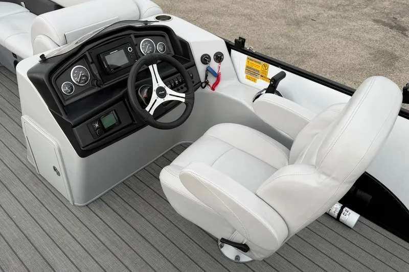 Slide: The Image of 2023 Bentley Pontoons Legacy 200 Cruise helm with steering wheel and control panel. - 7