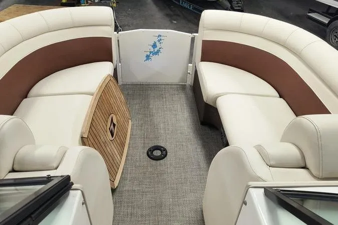 Slide: The Image of Interior of 2017 Larson Escape 213 boat with beige and brown seating. - 10