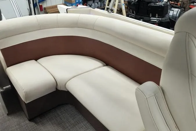 Slide: The Image of Luxurious seating in a 2017 Larson Escape 213 boat, featuring cream and brown upholstery. - 12