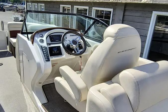 Slide: The Image of 2017 Larson Escape 213 boat interior with steering wheel and dashboard controls. - 14