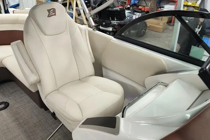 Slide: The Image of 2017 Larson Escape 213 boat interior with beige seating and modern design. - 16