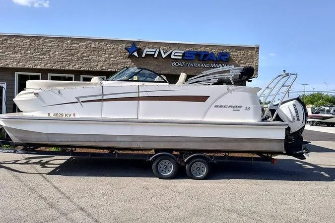 Slide: The Image of 2017 Larson Escape 213 boat on trailer at Five Star Boat Center. - 2