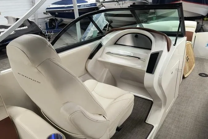 Slide: The Image of Interior of a 2017 Larson Escape 213 boat with beige seating and modern dashboard. - 5