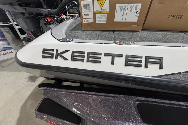 Slide: The Image of Manufacturer Provided Image: 2026 Skeeter FXR21 FLEX boat speeding on a lake with two passengers. - 12