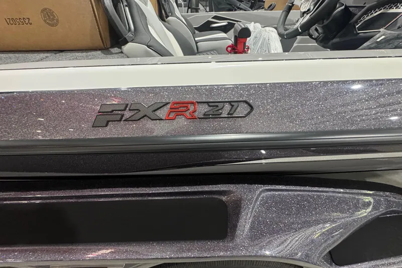 Slide: The Image of Manufacturer Provided Image: 2026 Skeeter FXR21 FLEX boat cruising on water with two passengers. - 13