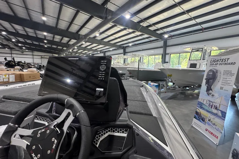 Slide: The Image of Manufacturer Provided Image: Top view of 2026 Skeeter FXR21 FLEX fishing boat with dual seats and motor. - 21