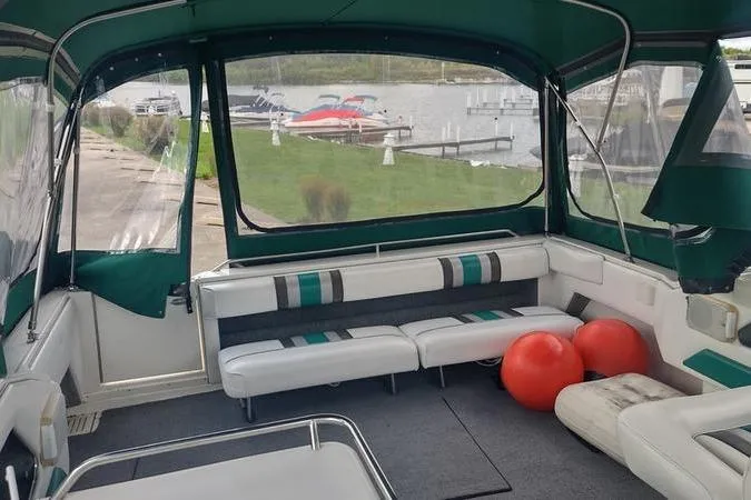 Slide: The Image of Interior of 1991 Sea Ray 280 Weekender boat with seating and dock view. - 11