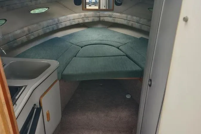 Slide: The Image of Interior of a 1991 Sea Ray 280 Weekender boat with a cozy cabin layout. - 13