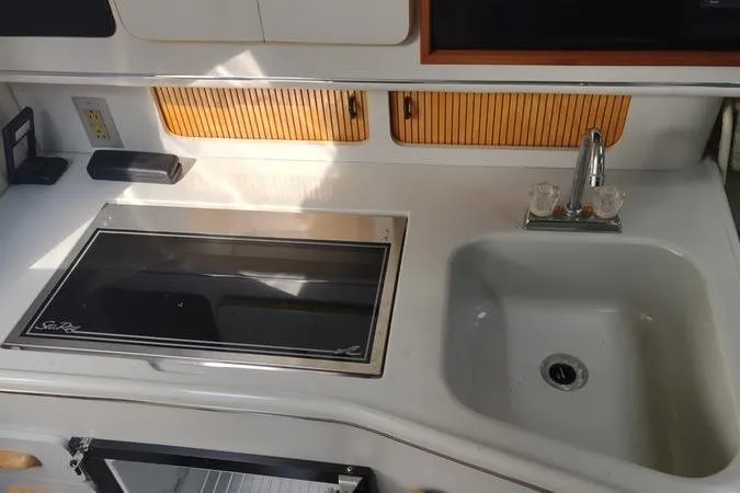 Slide: The Image of 1991 Sea Ray 280 Weekender boat kitchen with stove and sink. - 15