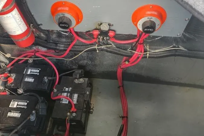 Slide: The Image of Electrical system of a 1991 Sea Ray 280 Weekender boat, featuring batteries and wiring. - 19
