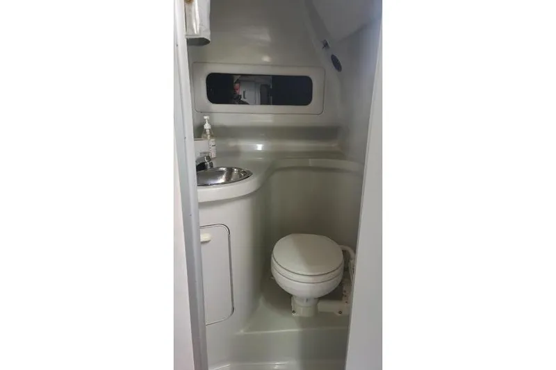 Slide: The Image of Interior of 1991 Sea Ray 280 Weekender boat bathroom with sink and toilet. - 23