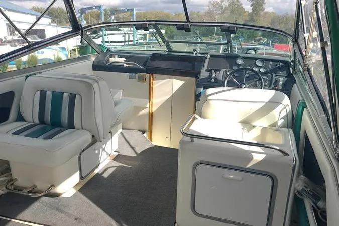 Slide: The Image of Interior of a 1991 Sea Ray 280 Weekender boat with seating and dashboard. - 24