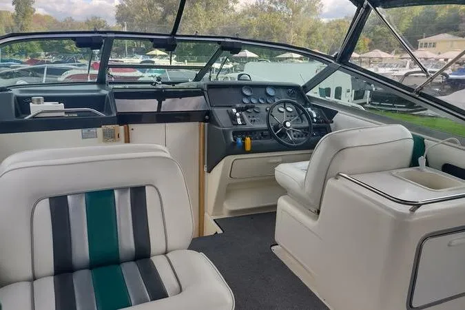 Slide: The Image of Interior of a 1991 Sea Ray 280 Weekender boat with steering wheel and seating. - 25