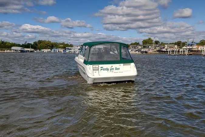 Slide: The Image of 1991 Sea Ray 280 Weekender boat on water, green canopy, "Party for Two" text on back. - 6