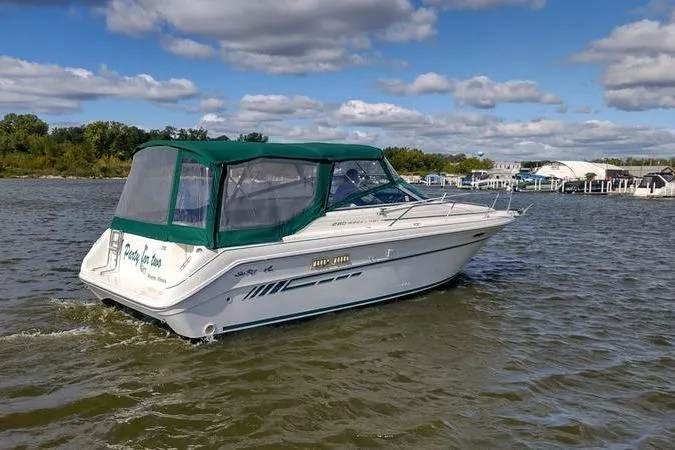 Slide: The Image of 1991 Sea Ray 280 Weekender boat on a lake under a partly cloudy sky. - 7