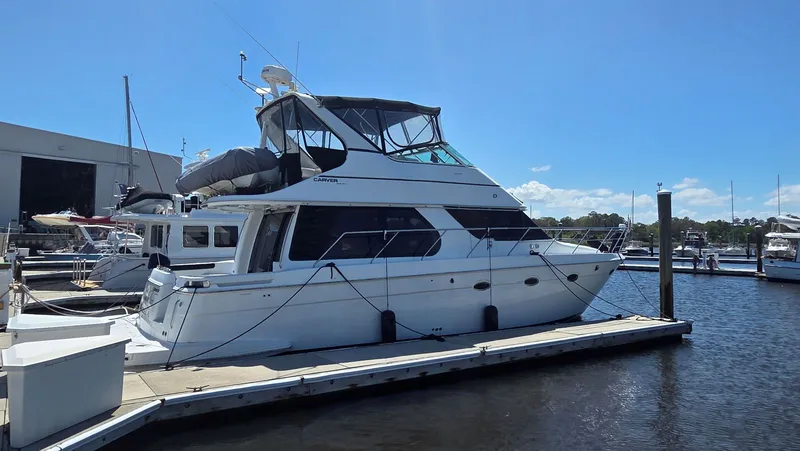 The Image of 2000 Carver 450 Voyager Pilothouse docked at marina. - 0