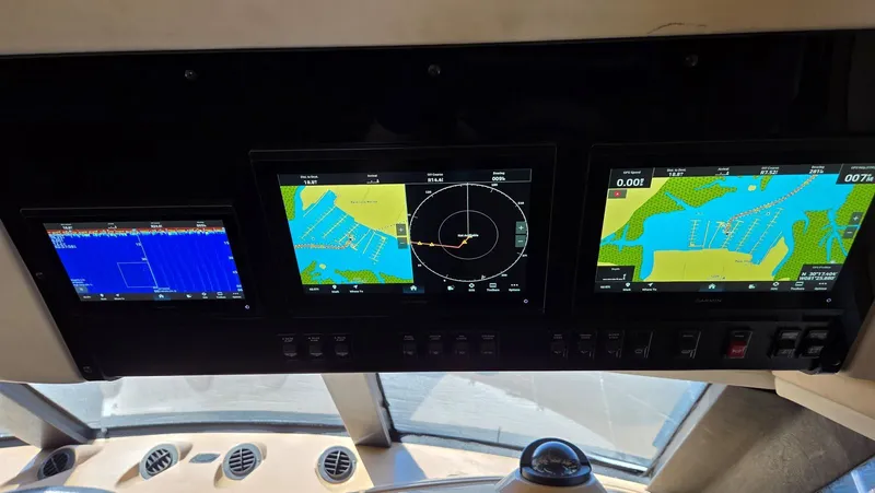 Slide: The Image of 2000 Carver 450 Voyager Pilothouse navigation system with map display. - 11