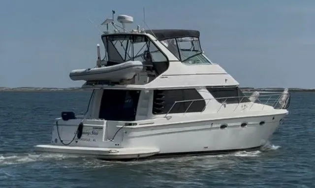 Slide: The Image of 2000 Carver 450 Voyager Pilothouse on the water. - 2