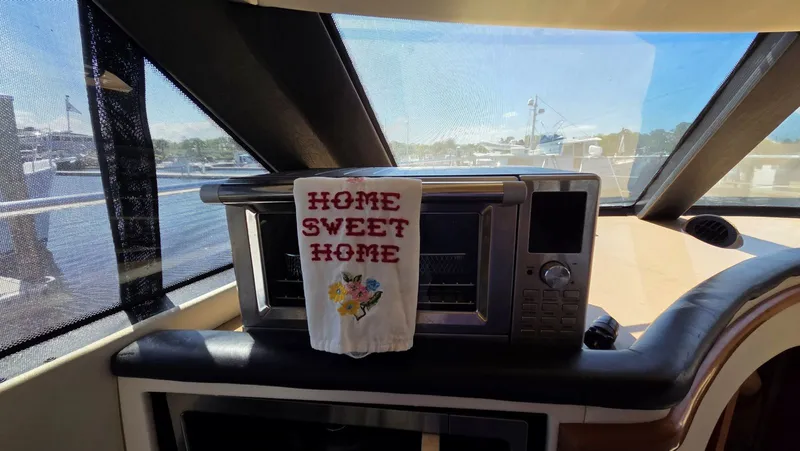 Slide: The Image of Interior of Carver 450 Voyager Pilothouse with "Home Sweet Home" towel. - 22