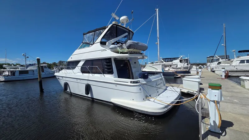 Slide: The Image of 2000 Carver 450 Voyager Pilothouse docked at marina. - 4