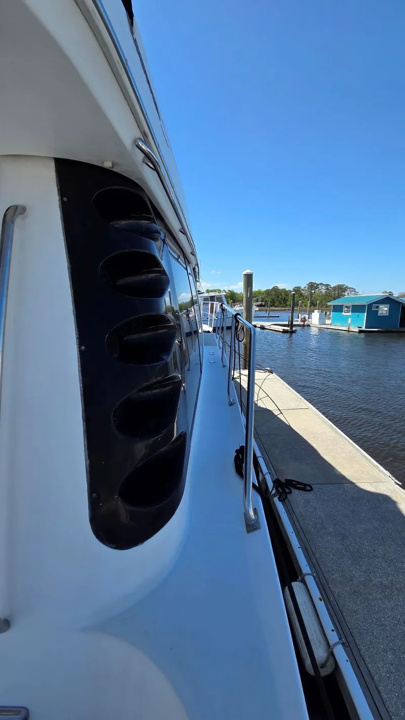 Slide: The Image of Side view of Carver 450 Voyager Pilothouse yacht at dock. - 48