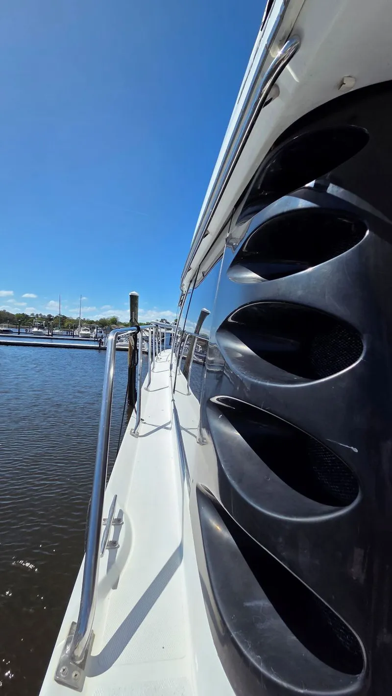 Slide: The Image of Side view of 2000 Carver 450 Voyager Pilothouse yacht by the water. - 49