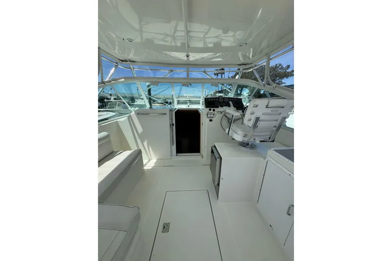 Slide: The Image of 1998 Cabo Yachts 35 Express interior with helm, seating, and navigation equipment. - 18