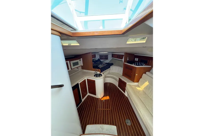 Slide: The Image of Interior of 1998 Cabo Yachts 35 Express with wood flooring and cozy seating area. - 22