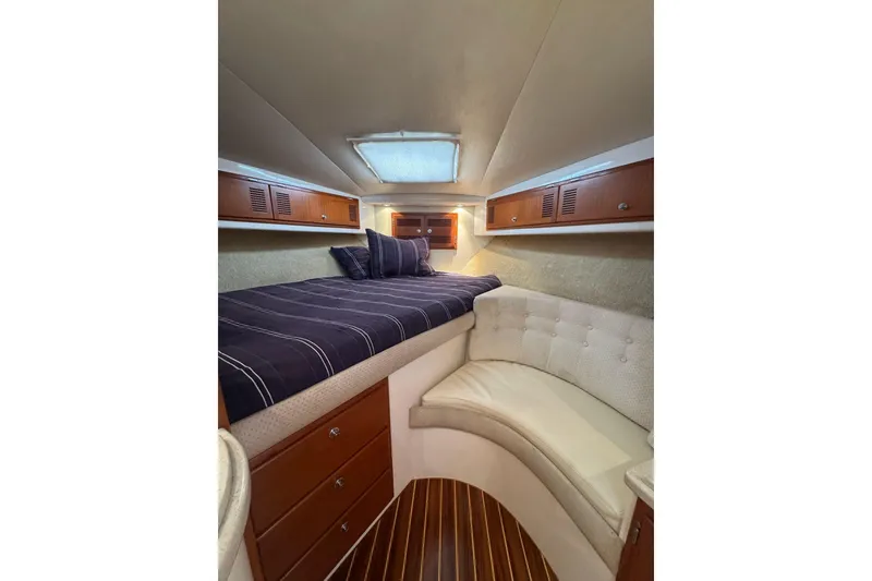 Slide: The Image of Cozy cabin interior of 1998 Cabo Yachts 35 Express with bed and seating area. - 23