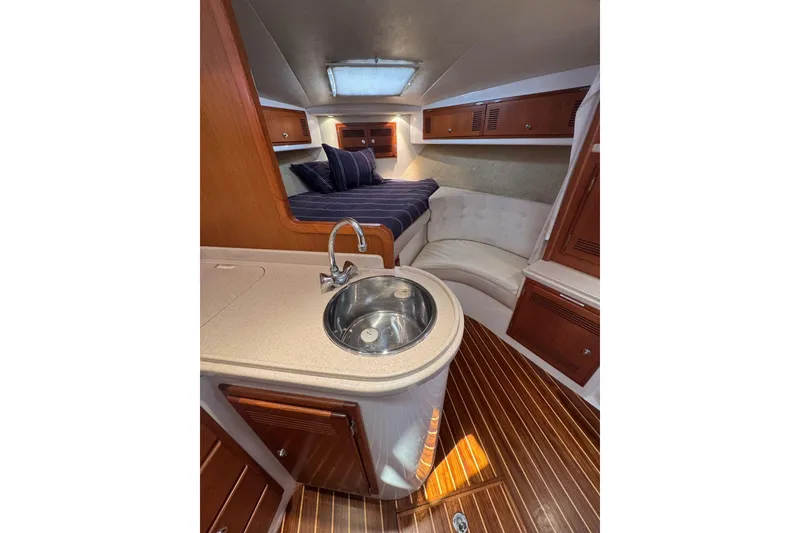 Slide: The Image of 1998 Cabo Yachts 35 Express interior with kitchenette, bed, and seating area. - 27