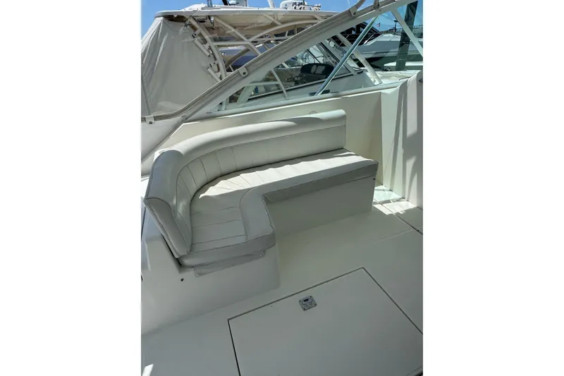 Slide: The Image of 1998 Cabo Yachts 35 Express boat interior with white cushioned seating. - 28