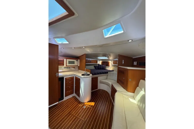 Slide: The Image of Luxurious interior of a 1998 Cabo Yachts 35 Express with wood accents and modern amenities. - 29