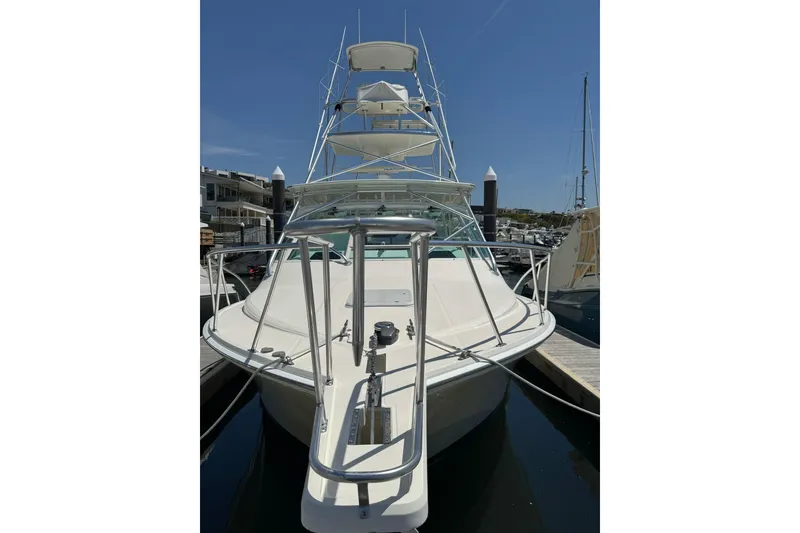 Slide: The Image of 1998 Cabo Yachts 35 Express docked, showcasing sleek design and sturdy build. - 3