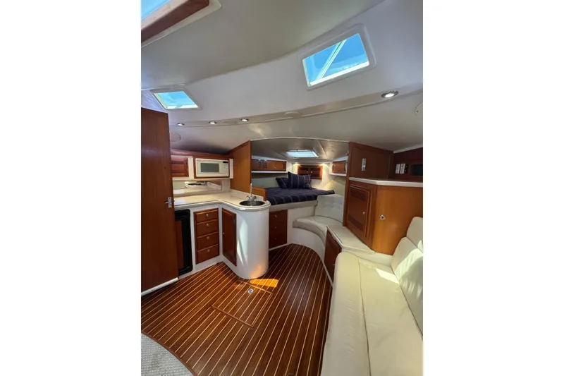 Slide: The Image of Luxurious interior of 1998 Cabo Yachts 35 Express with wood flooring and modern amenities. - 35