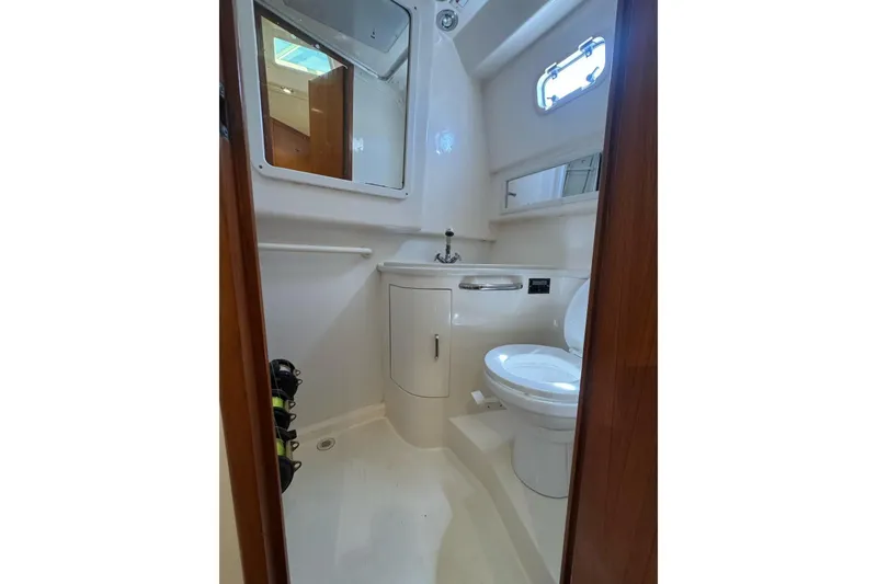 Slide: The Image of Bathroom interior of 1998 Cabo Yachts 35 Express, featuring toilet and sink. - 36
