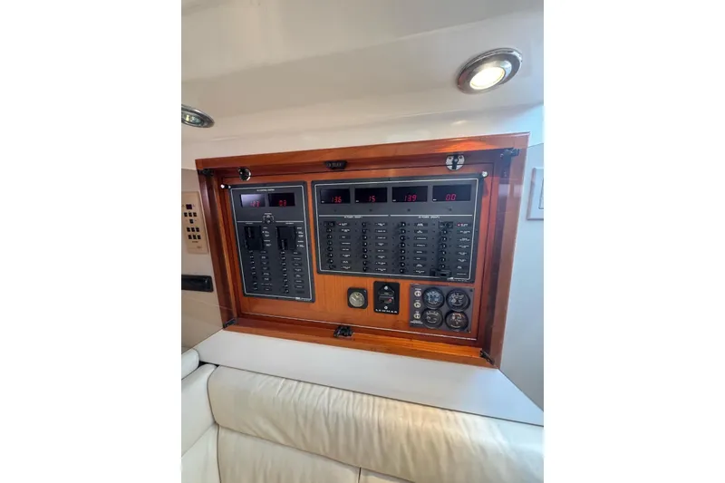 Slide: The Image of Electrical panel of a 1998 Cabo Yachts 35 Express, featuring gauges and switches. - 43