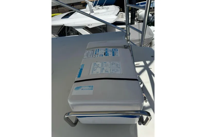 Slide: The Image of Life raft on 1998 Cabo Yachts 35 Express deck, secured with metal railing. - 44
