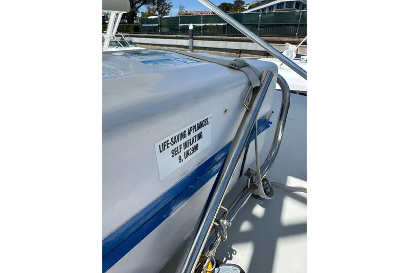Slide: The Image of 1998 Cabo Yachts 35 Express with life-saving appliance, self-inflating, docked at marina. - 45
