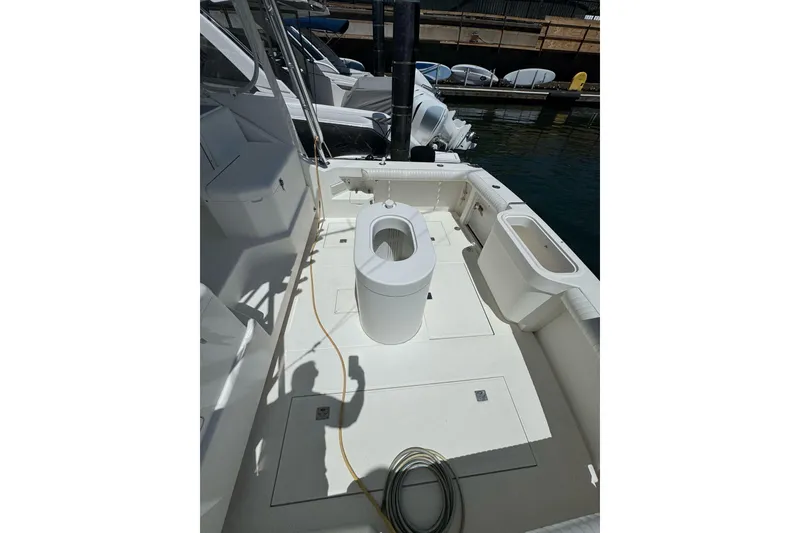 Slide: The Image of 1998 Cabo Yachts 35 Express boat deck with seating and storage compartments. - 48