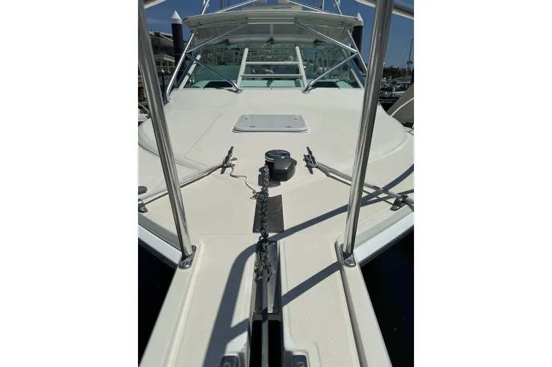 Slide: The Image of 1998 Cabo Yachts 35 Express boat deck with railing and anchor chain. - 5